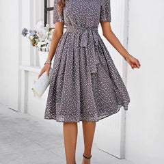 Gray polka-dot midi dress with short sleeves, gathered waist, and full skirt