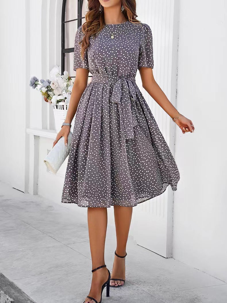 Gray polka-dot midi dress with short sleeves, gathered waist, and full skirt