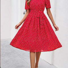Red polka-dot midi dress with short sleeves and gathered waist, wide flared skirt