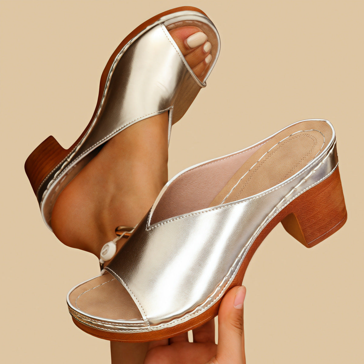 Gold metallic heeled mule sandals with open toe and side strap, wood-look block heel