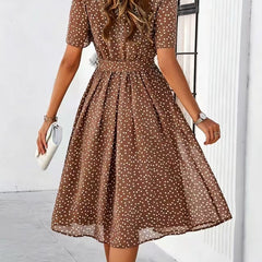 Brown polka-dot dress with short sleeves and tie waist, flared midi skirt (back view)