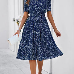 Navy polka-dot lace-up dress with short sleeves and tie waist, flared midi skirt
