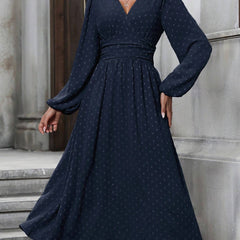 Navy blue dotted pleated dress with diagonal V neckline and long lantern sleeves