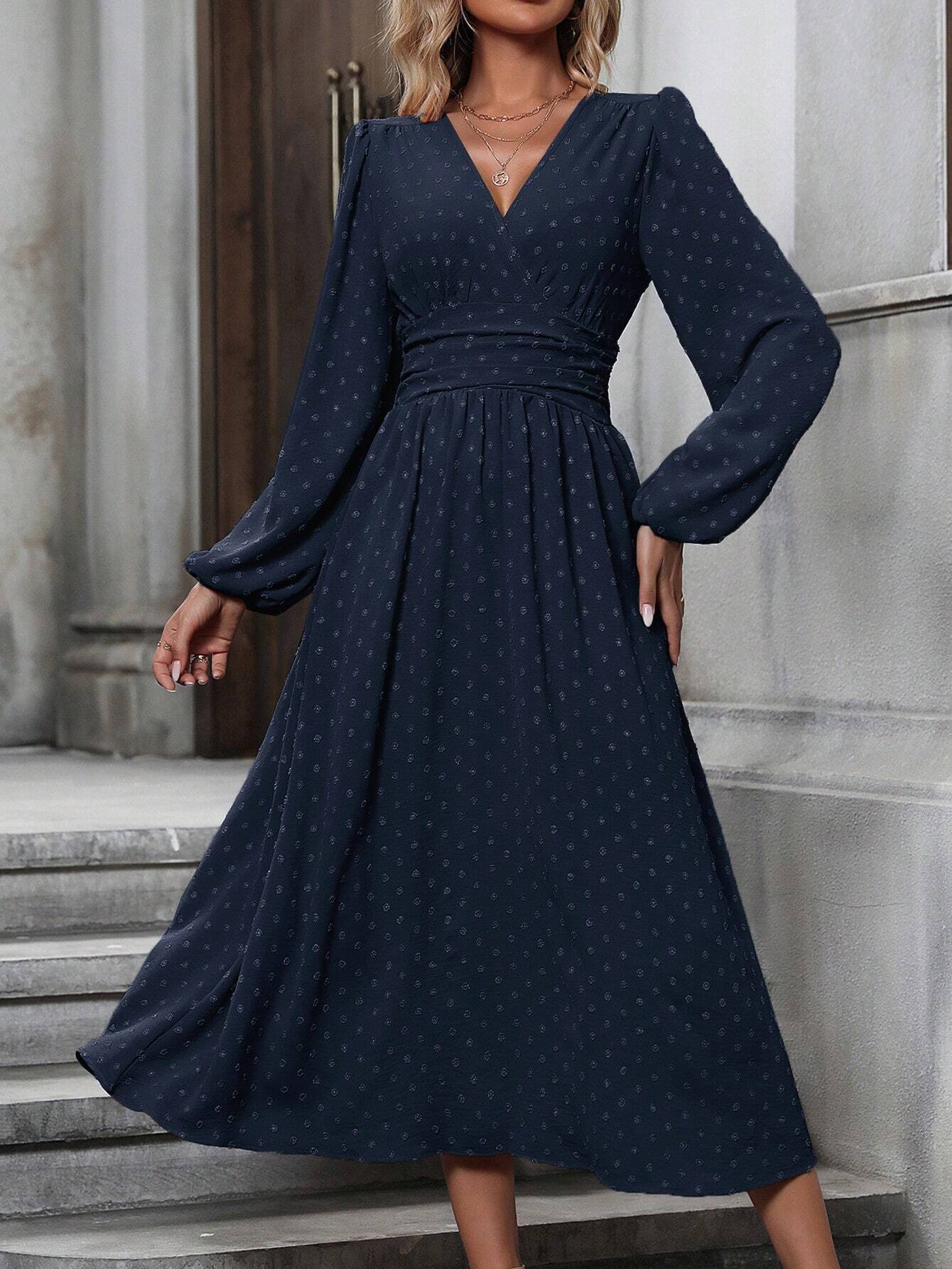 Navy blue dotted pleated dress with diagonal V neckline and long lantern sleeves