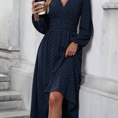 Navy blue dotted pleated lantern-sleeve dress with diagonal V neckline and asym hem