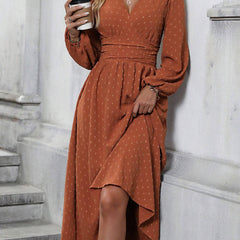 Brick red dotted pleated lantern-sleeve dress with diagonal V neckline and asymmetrical hem