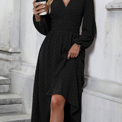Black dotted pleated lantern-sleeve dress with diagonal V neckline and asymmetrical hem