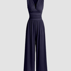 Navy sleeveless wide-leg jumpsuit with V-neck, ruched bodice and gathered waist.