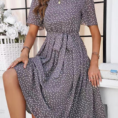 Gray polka-dot midi dress with short sleeves and gathered waist, flowing tiered skirt