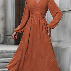 Brick red dotted pleated dress with diagonal V neckline and long lantern sleeves