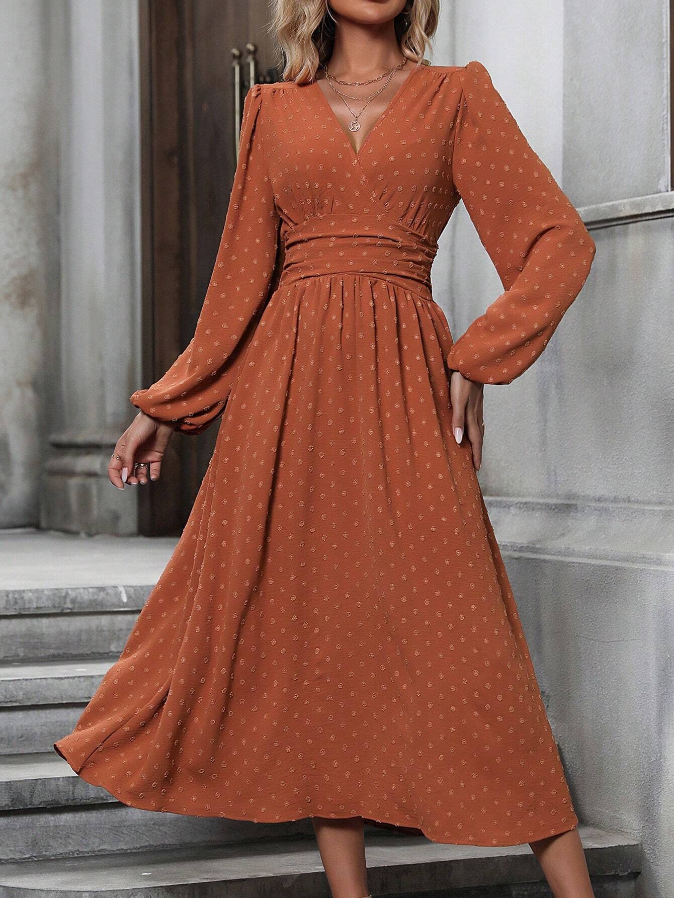 Brick red dotted pleated dress with diagonal V neckline and long lantern sleeves