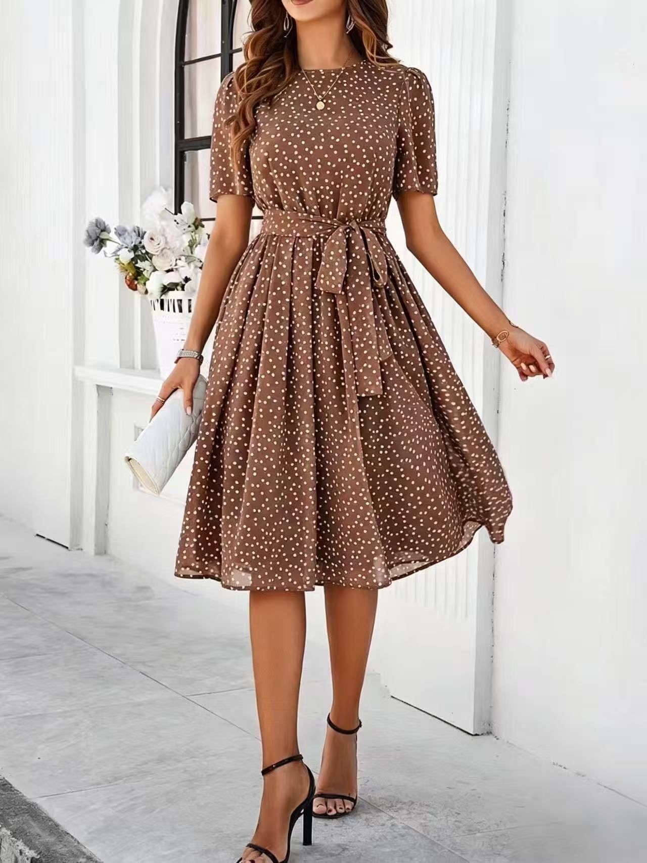 Brown polka-dot dress with short sleeves, tie waist, and flared midi skirt