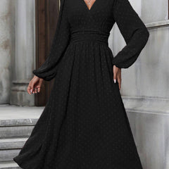 Black dotted pleated dress with diagonal V neckline and long lantern sleeves
