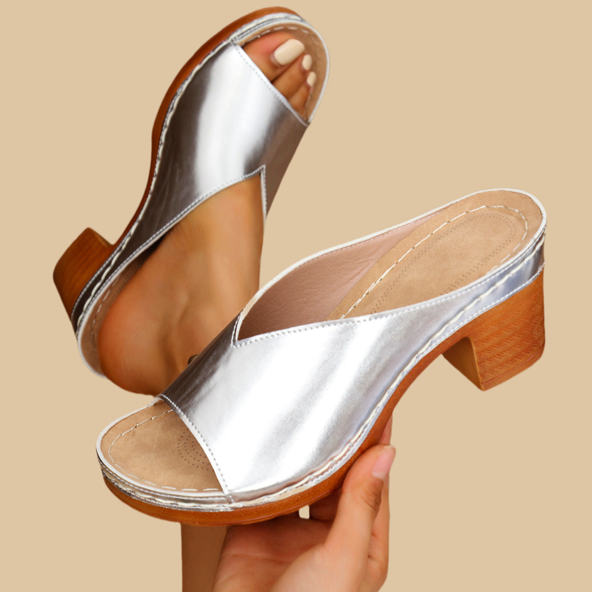 Silver metallic heeled mule sandals with open toe and side strap, wood-look block heel