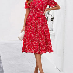 Red polka-dot midi dress with short sleeves and gathered waist, full skirt