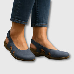 Blue comfort slip-on shoes with cutout sides and cushioned, low wedge heel