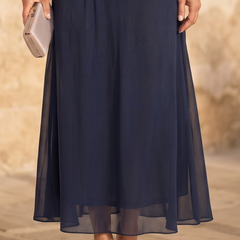 Dark blue chiffon maxi skirt with gathered waist, flowing pleats, midi hem