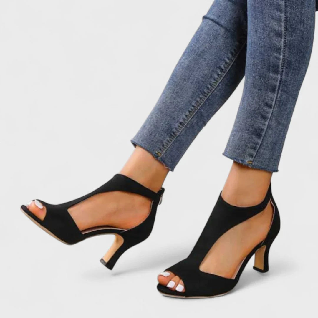 Black open-toe heeled sandals with ankle strap and low block heel