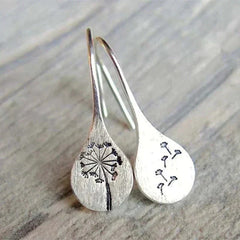 Silver teardrop dangle earrings with engraved dandelion line art and small leaf details