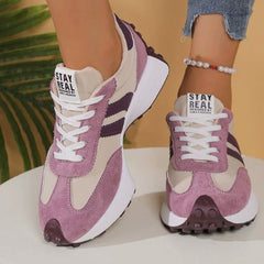 Purple comfort sneakers with white side stripes and lace-up front, chunky sole