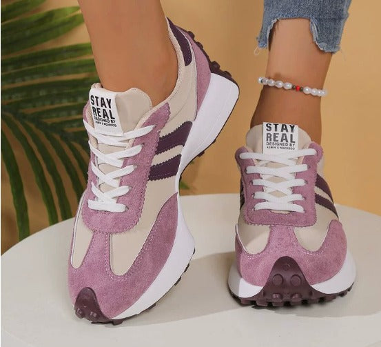 Purple comfort sneakers with white side stripes and lace-up front, chunky sole