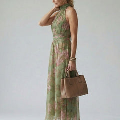 Sage green gathered halter midi dress with pink floral print, side view, flowing skirt