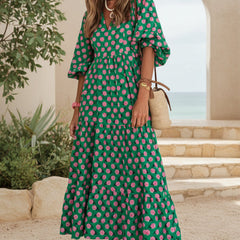Bohemian dress in dark green with pink floral print, short sleeves, tiered maxi length