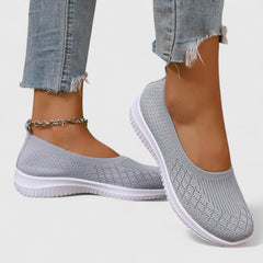 Gray knit slip-on sneakers with white sole and ankle chain detail