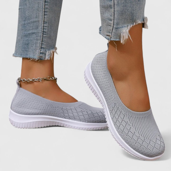 Gray knit slip-on sneakers with white sole and ankle chain detail