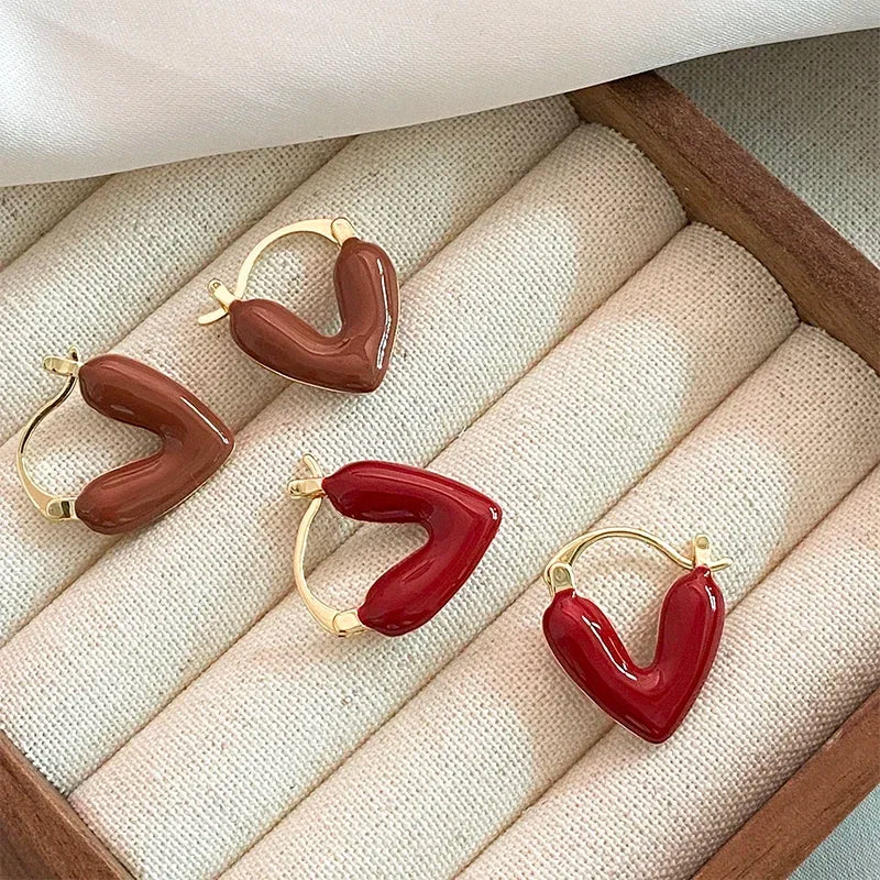 Gold heart hoop earrings with brown and red resin heart details