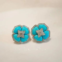 Turquoise flower stud earrings with silver-tone beaded edges and crystal star centers