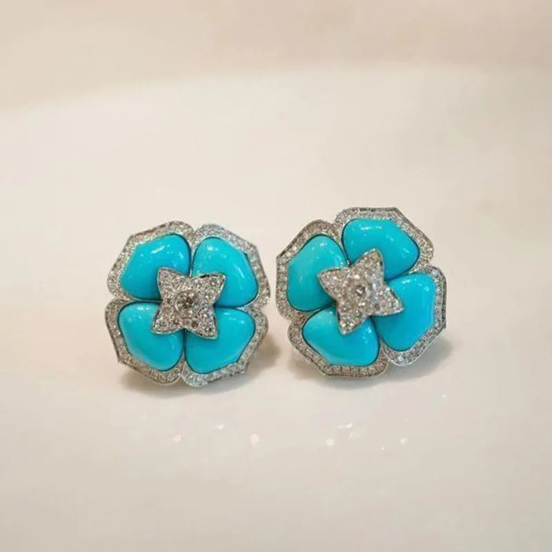 Turquoise flower stud earrings with silver-tone beaded edges and crystal star centers