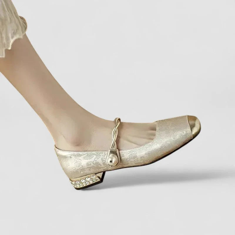 Beige orthopedic Mary Jane flats with gold buckle strap and low block heel, patterned leather