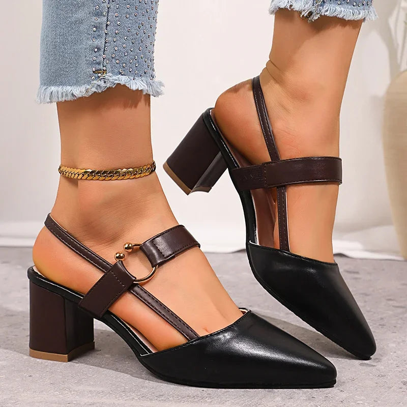 Black heeled slingbacks with ring buckle, ankle strap, and gold chain
