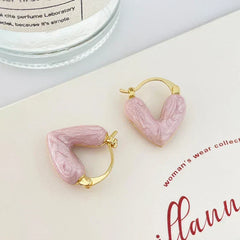 Gold heart hoop earrings with pink resin heart details