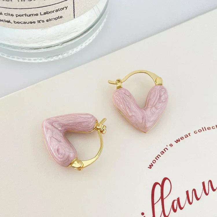 Gold heart hoop earrings with pink resin heart details