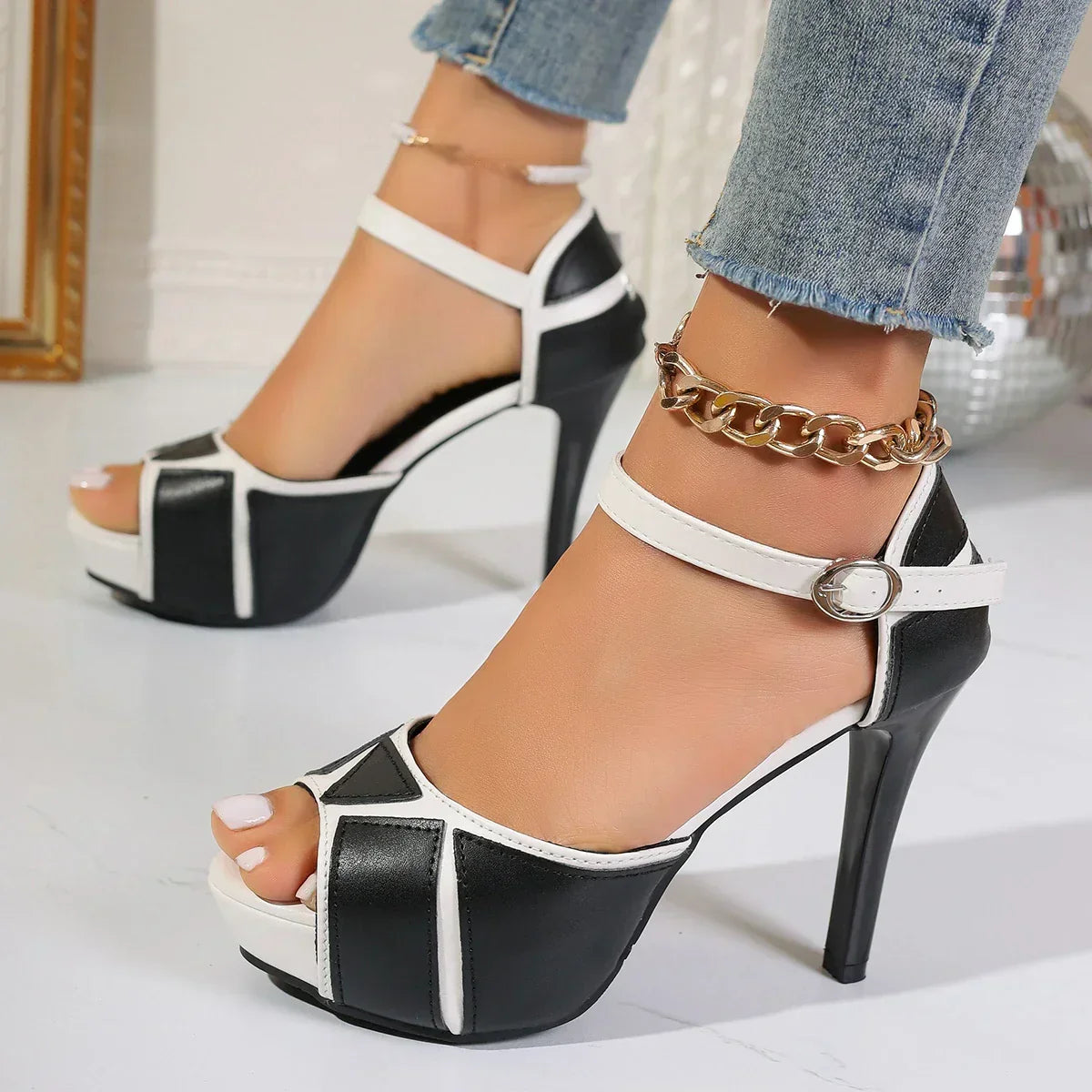 Two-tone white and black high heels with ankle strap and peep-toe