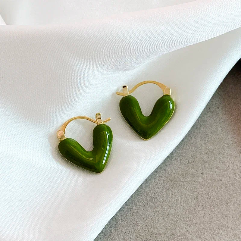 Dark green heart hoop earrings with gold-tone hooks, sculpted heart pair.