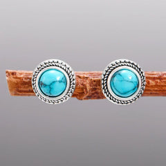 Pair of round turquoise stud earrings in ornate silver frames