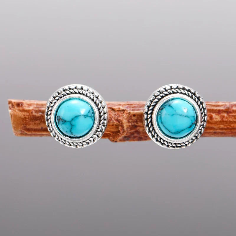 Pair of round turquoise stud earrings in ornate silver frames