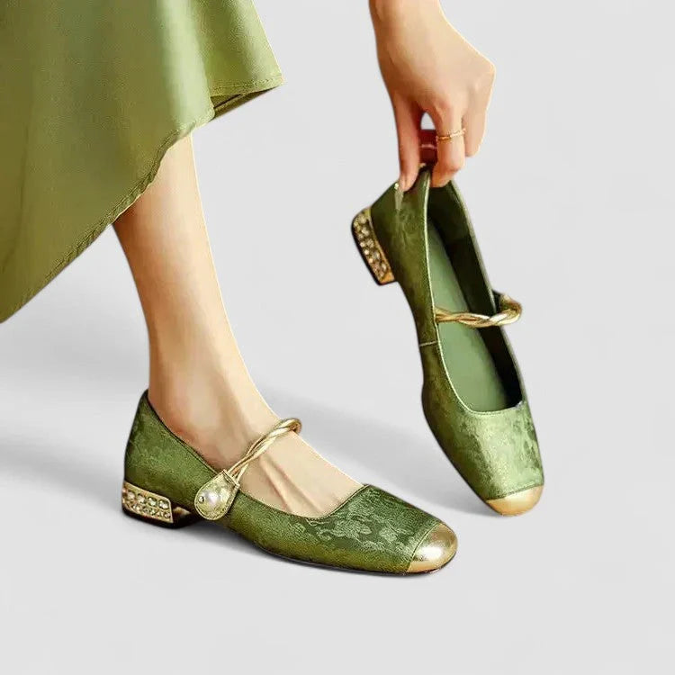 Green orthopedic Mary Jane shoes with gold buckle strap and low block heel, patterned toe
