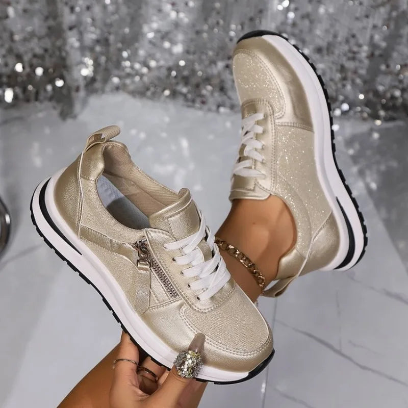 Gold glitter zip-up comfort sneakers with white laces, side zipper, and black-trim sole