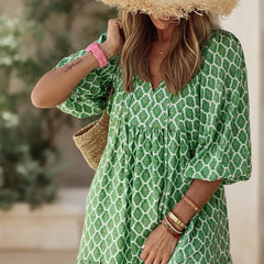Bohemian dress in green with white geometric print, gathered neckline, short puff sleeves