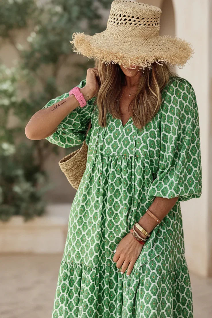 Bohemian dress in green with white geometric print, gathered neckline, short puff sleeves
