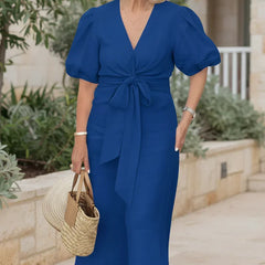 V-neck midi dress in navy blue with puff sleeves and tied waist.