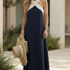 Navy maxi dress with halter neckline and ivory crisscross strap detail