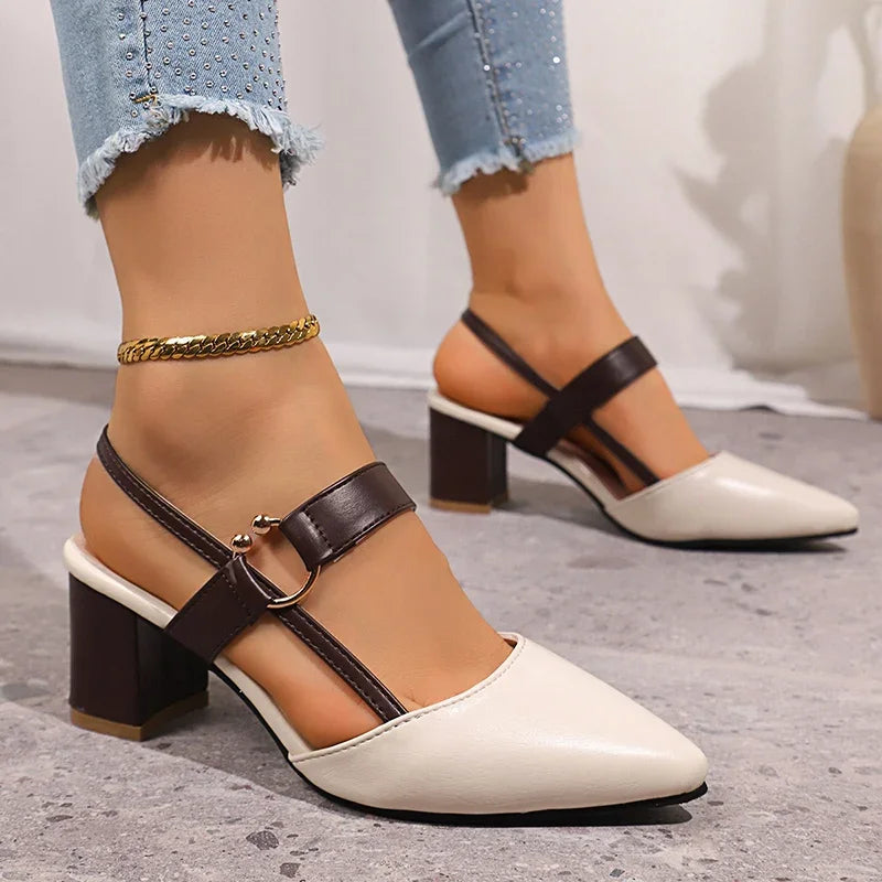 White heeled slingbacks with ring buckle, black straps, and gold ankle chain