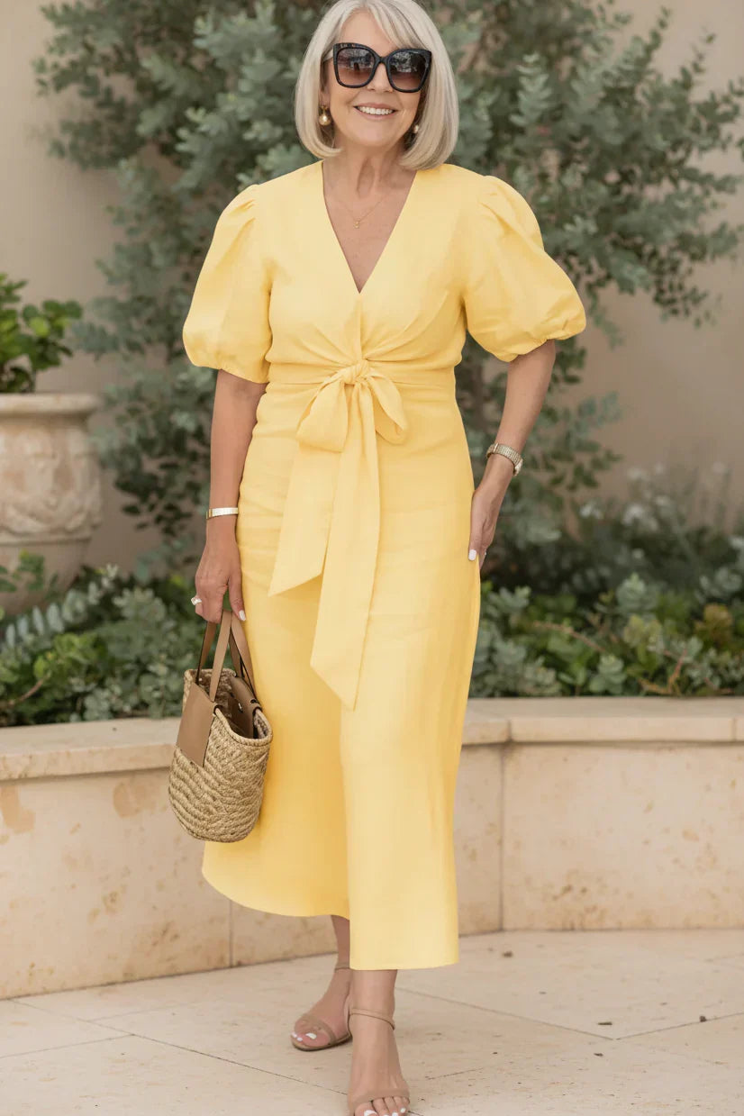 V-neck midi dress in lemon yellow with puff sleeves and tied waist.