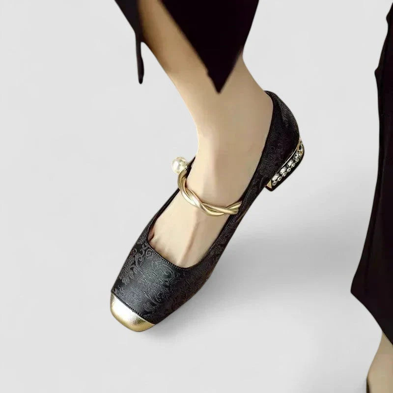 Orthopedic shoes, black textured ballet-style with gold toe cap and curved ankle strap