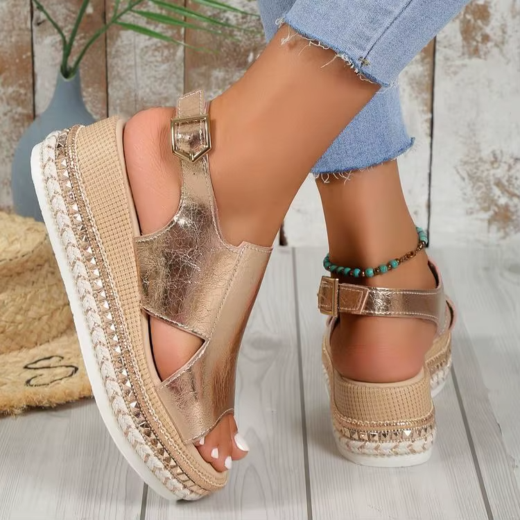 Silver metallic wedge sandals with ankle strap buckle, open toe, and textured platform sole